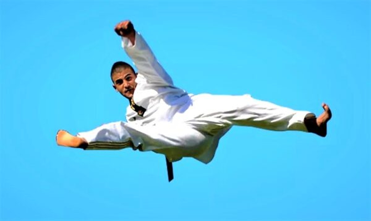 Pinnacle Martial Arts Taekwondo athlete performing a flying kick
