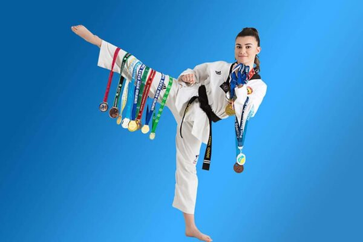 Pinnacle Martial Arts Taekwondo athlete wearing competition medals